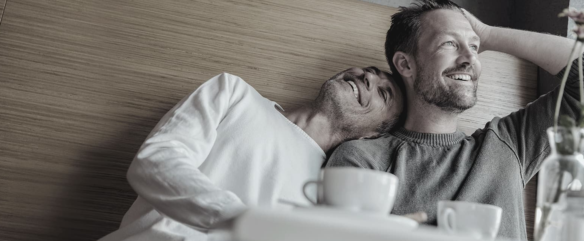 Pareja sentada en una mesa sonriendo y conversando